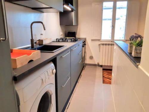 a kitchen with a sink and a washing machine at Your apartment in the Heart of Florence in Florence