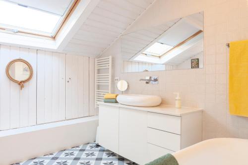 a white bathroom with a sink and a mirror at Alfama Stunning River and Historic City Views 2Bedrooms & 2Bathrooms AC Balcony 18th Century Building in Lisbon