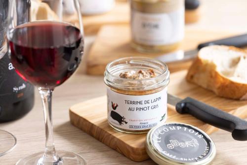a glass of wine and a jar of bread and a glass of red wine at Hotel La Diligence in Obernai