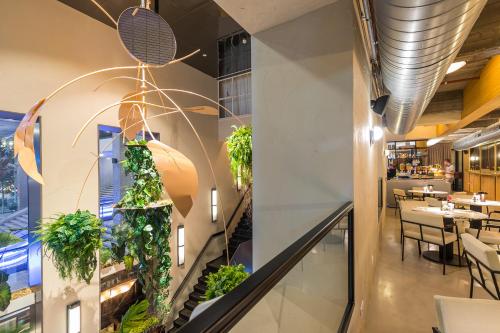 a restaurant with plants on the wall at Postillion Hotel WTC Rotterdam in Rotterdam
