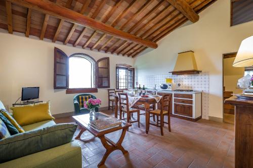 a living room with a couch and a table at Villa S.Andrea in San Casciano in Val di Pesa