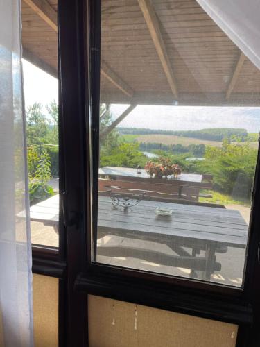 a view from a window of a table with a bench at AgroGłęboczek Karbowski Waldemar in Mały Głęboczek