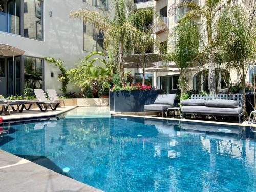 a large blue swimming pool in a building at The Village Boutique and SPA in Naxxar