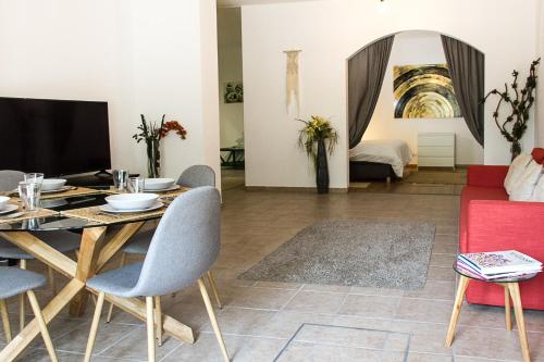 a living room with a table and a couch at Bairro das Flores in Tomar