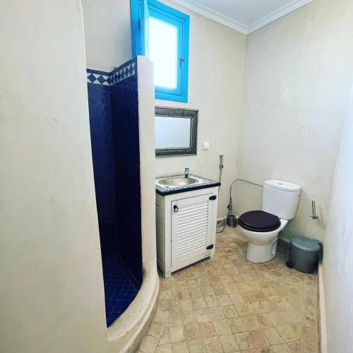 a bathroom with a toilet and a sink at Taghazout Ocean View in Taghazout