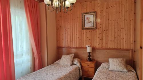 1 Schlafzimmer mit 2 Betten und einem Fenster in der Unterkunft Casa David in Tríacastela