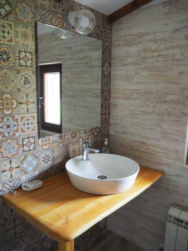 a bathroom with a sink and a mirror at Къща за гости Младата Баба in Apriltsi