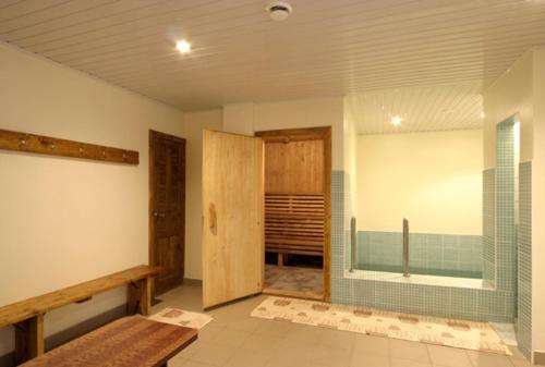 a bathroom with a shower and a glass door at Viesu nams Vizbulītes in Talsi