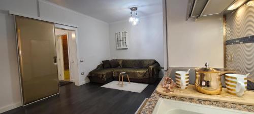 a living room with a couch and a table at Oro Apartments Tirana in Tirana