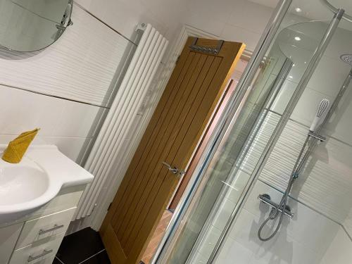 a bathroom with a shower and a glass door at Central Hull Spacious Apartment H3 in Hull