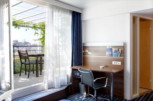 an office with a desk and a large window at Hôtel Marseille Centre Gare Saint-Charles in Marseille