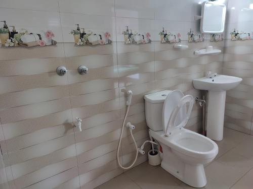 a bathroom with a toilet and a sink at Rest Point in Unawatuna