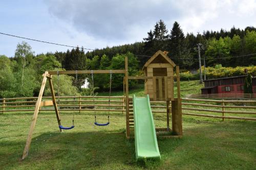 a playground with a slide and a swing at Acconat-Domaine du Moulin ( 8 Gîtes ) in Ban-de-Sapt