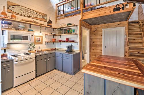 a large kitchen with wooden walls and wooden counters at Mountain View Escape - 1 Mile to White River! in Mountain View