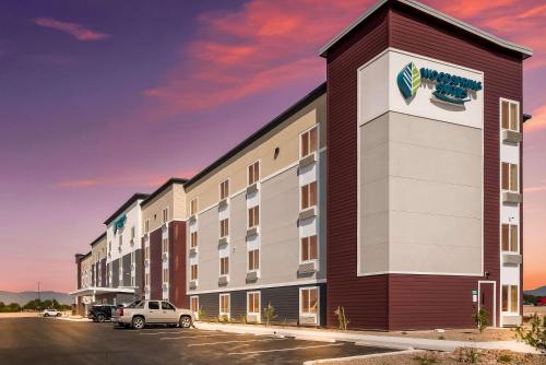a rendering of a building with a parking lot at WoodSpring Suites Tucson-South in Tucson