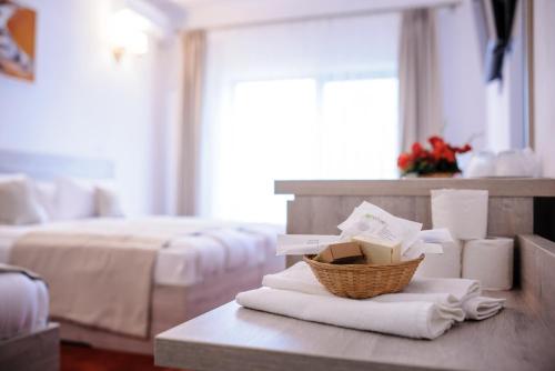 a room with two beds and a table with towels at Hotel Class in Brezoi