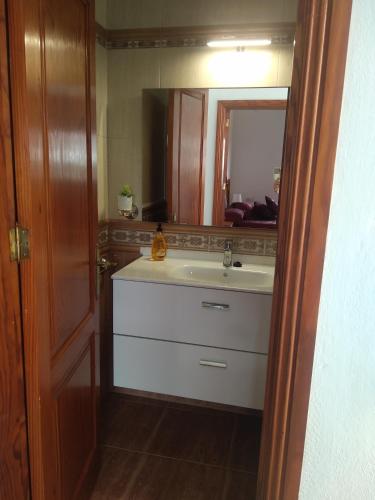 a bathroom with a sink and a mirror at adosado cerca del mar in Playa Honda
