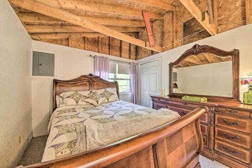 a bedroom with a bed and a mirror and a dresser at Rustic Retreat Across from Lake Family Friendly! in Union