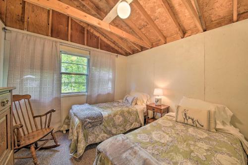 a bedroom with two beds and a chair and a window at Rustic Retreat Across from Lake Family Friendly! in Union