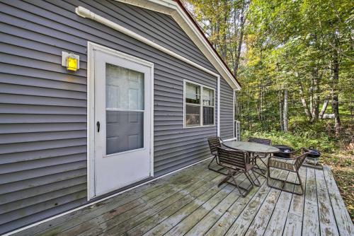 a patio with a table and chairs on a house at Rustic Retreat Across from Lake Family Friendly! in Union