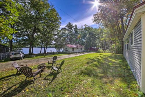 a group of chairs sitting on the grass next to a house at Rustic Retreat Across from Lake Family Friendly! in Union