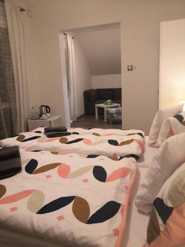 two beds in a bedroom with a cow blanket on them at Penzion Na Svahu in Cheb