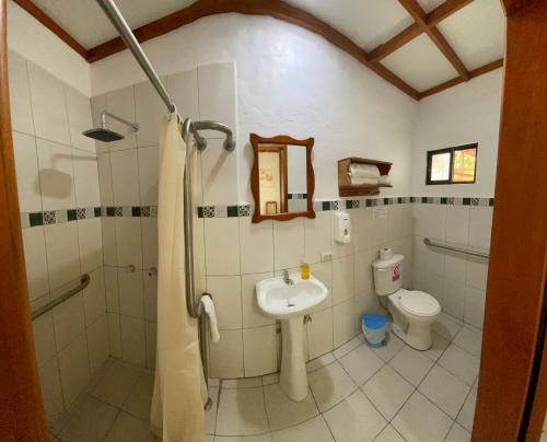 a bathroom with a sink and a toilet at La Peregrina Galapagos B&B in Puerto Ayora