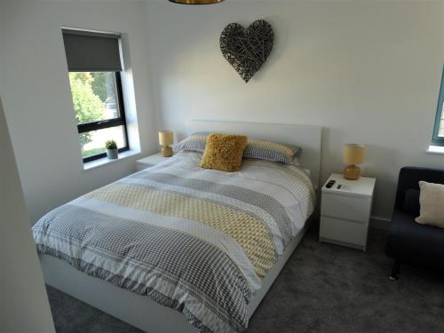 a bedroom with a bed and a heart on the wall at Old Station Apartments in Cambridge