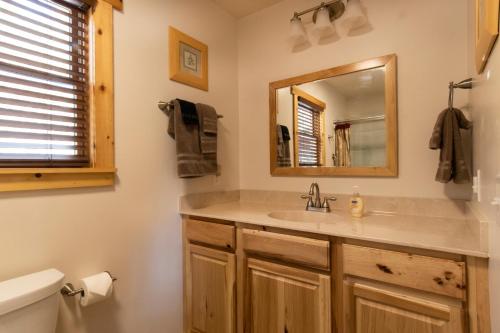 a bathroom with a sink and a mirror at Calhoun House Inn & Suites in Bryson City