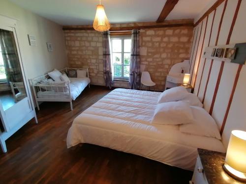 a bedroom with two beds and a window at Gite charm'en Vexin in Neuilly-en-Vexin