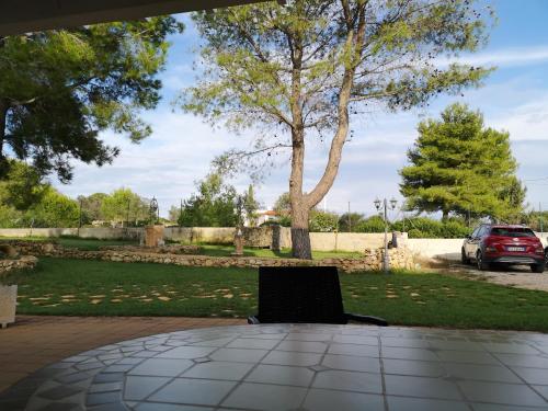 a laptop sitting on a table under a tree at Aura Solis B&B in Leuca