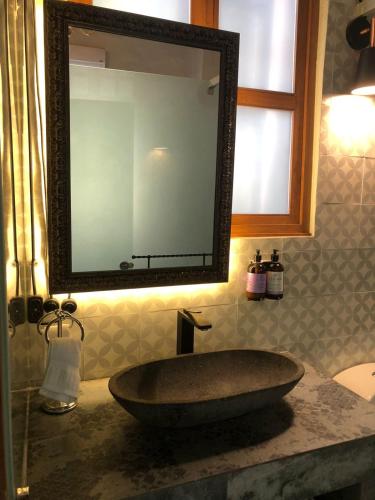 a bathroom sink with a large mirror on a counter at Los Camilos in Mexico City