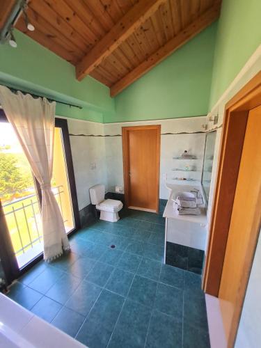 a bathroom with a sink and a toilet at Casa Spannika Pool And Gym in Zakynthos