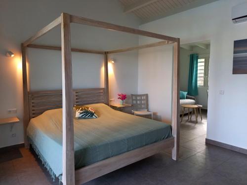 
a bedroom with a large bed and a large window at TIKO LODGE SXM in Oyster Pond
