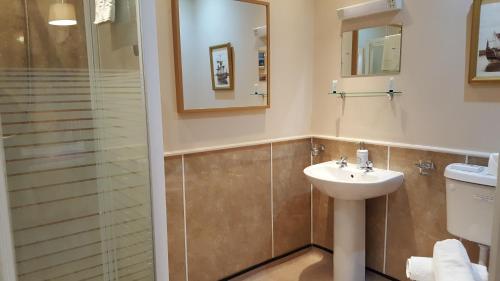 a bathroom with a sink and a shower at Moorgarth Guesthouse in York