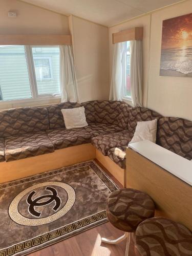 a living room with a couch and a table at Summer The Grange Ingoldmells 8 Berth in Ingoldmells