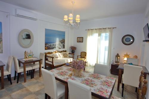 a dining room and living room with a table and chairs at Aspous Studios and Rooms in Skiros