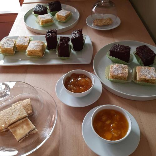 a table with plates of desserts and bowls of dips at Agriturismo Basegò in Venice