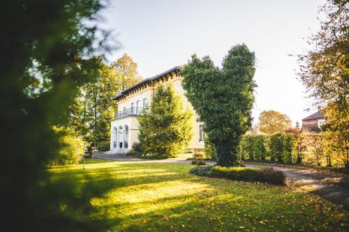 a large white building with a yard in front of it at Villa Aurelie in Velké Losiny