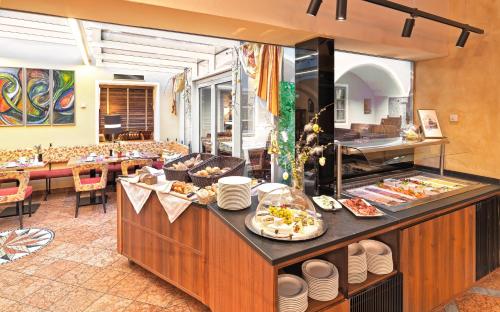 a restaurant with a buffet with food on it at Hotel Mader in Steyr