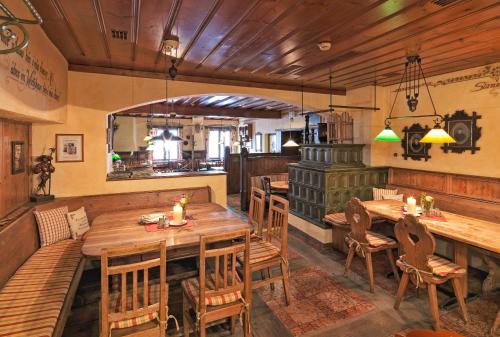 a restaurant with a wooden table and chairs at Hotel Mader in Steyr