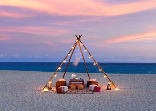 a tent on the beach with a table and chairs at Paradisus Los Cabos - Adults Only - All Inclusive in Cabo San Lucas