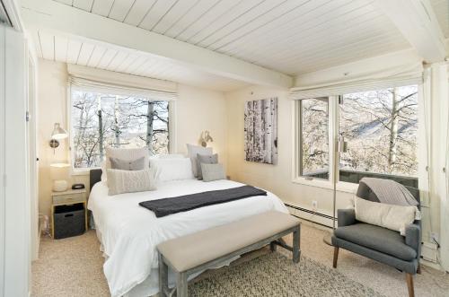 a bedroom with a bed and a chair and a window at Standard Two Bedroom - Aspen Alps #505 in Aspen