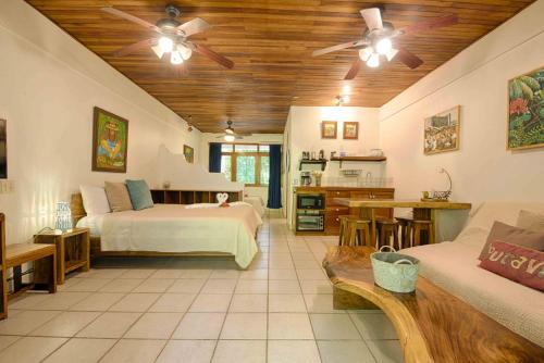 a bedroom with two beds and a living room at Casa Sueca Hotel - At the Beach in Tamarindo
