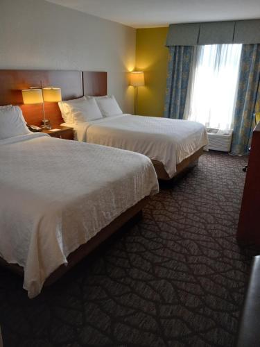 a hotel room with two beds and a window at Holiday Inn Express & Suites Jacksonville South - I-295 by IHG in Jacksonville