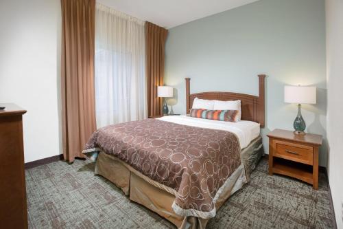 a hotel room with a bed and a window at Staybridge Suites Augusta by IHG in Augusta