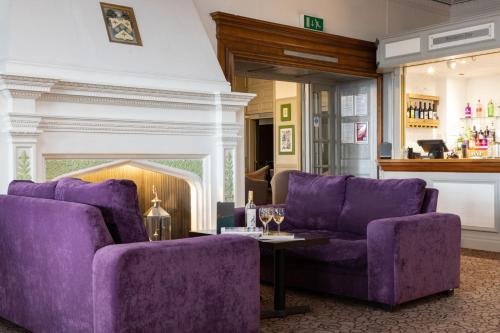 a living room filled with couches and chairs at The Torbay Hotel in Torquay