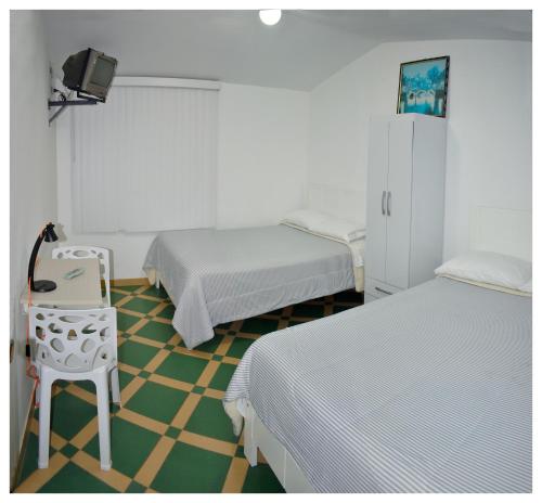 Postel nebo postele na pokoji v ubytování Hospedaje La Casa Blanca