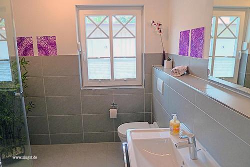 a bathroom with a sink and a toilet at Villa Morgentied, FW 1 in Zingst