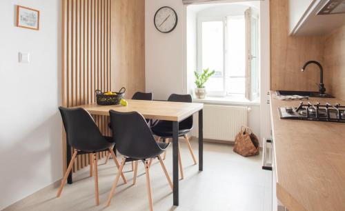 - une cuisine avec une table et des chaises dans la chambre dans l'établissement Baštova apartment, à Bratislava